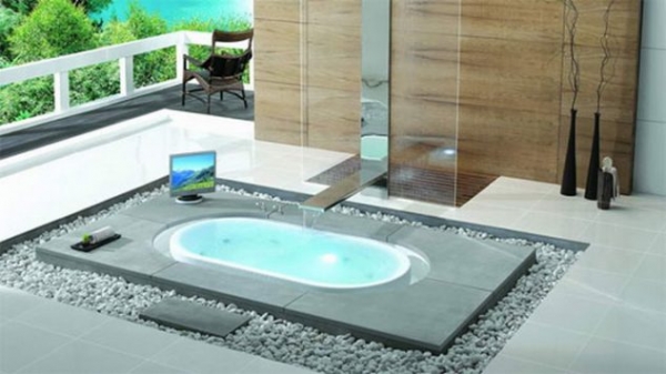 ванна по середині кімнати у вигляді острова, втопленого у підлогу, навколо ванни каміння